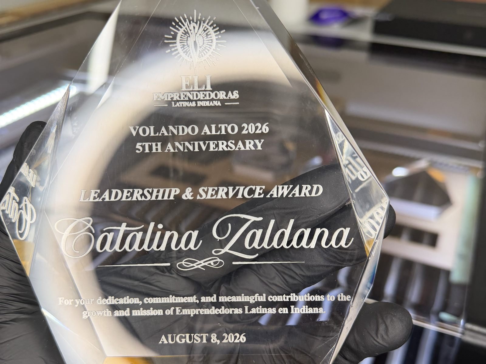 Engraved acrylic leadership award held in the workshop