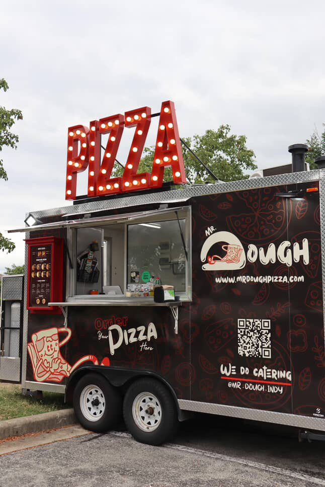 Wrapped food trailer with illuminated marquee letters for Mr. Dough Pizza